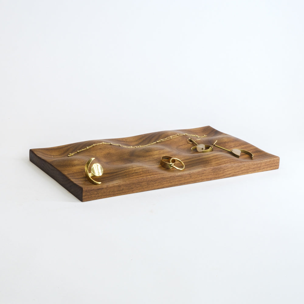The Topo Tray in Walnut pictured with delicate jewelry
