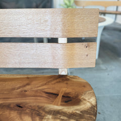 Close-up of a wooden chair with a blurred background