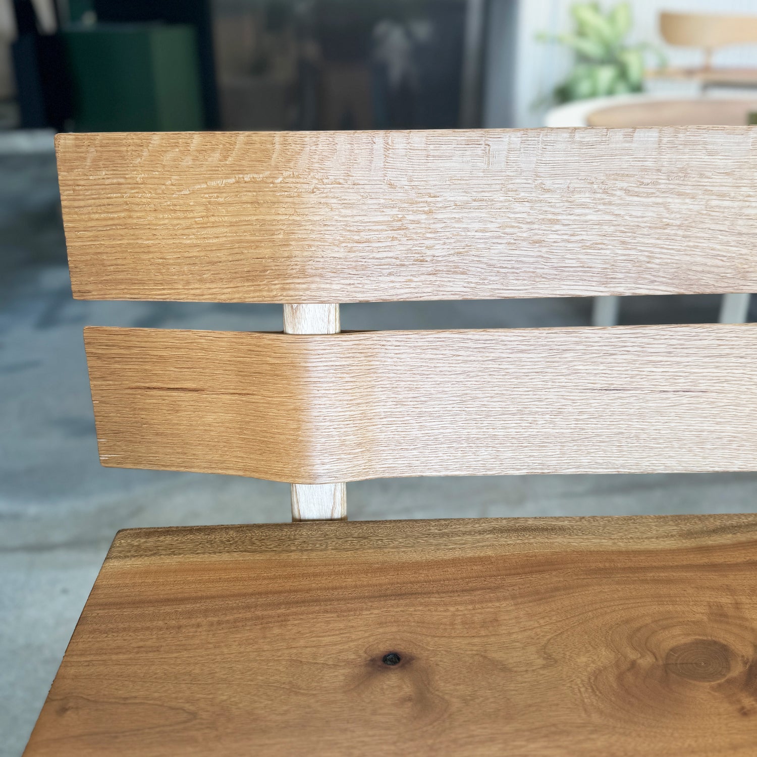 Close-up of a wooden chair with a blurred background