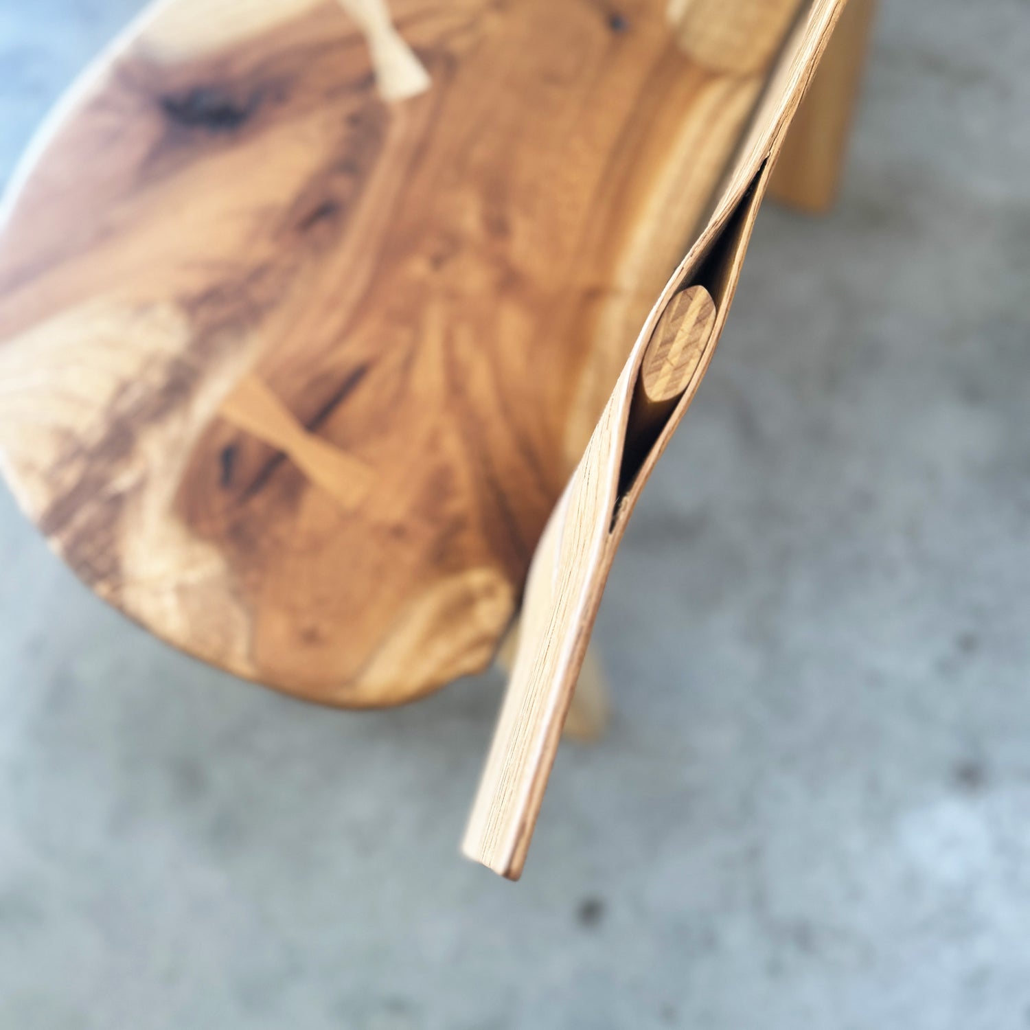 Wood bench detail with blurred background, concrete floor