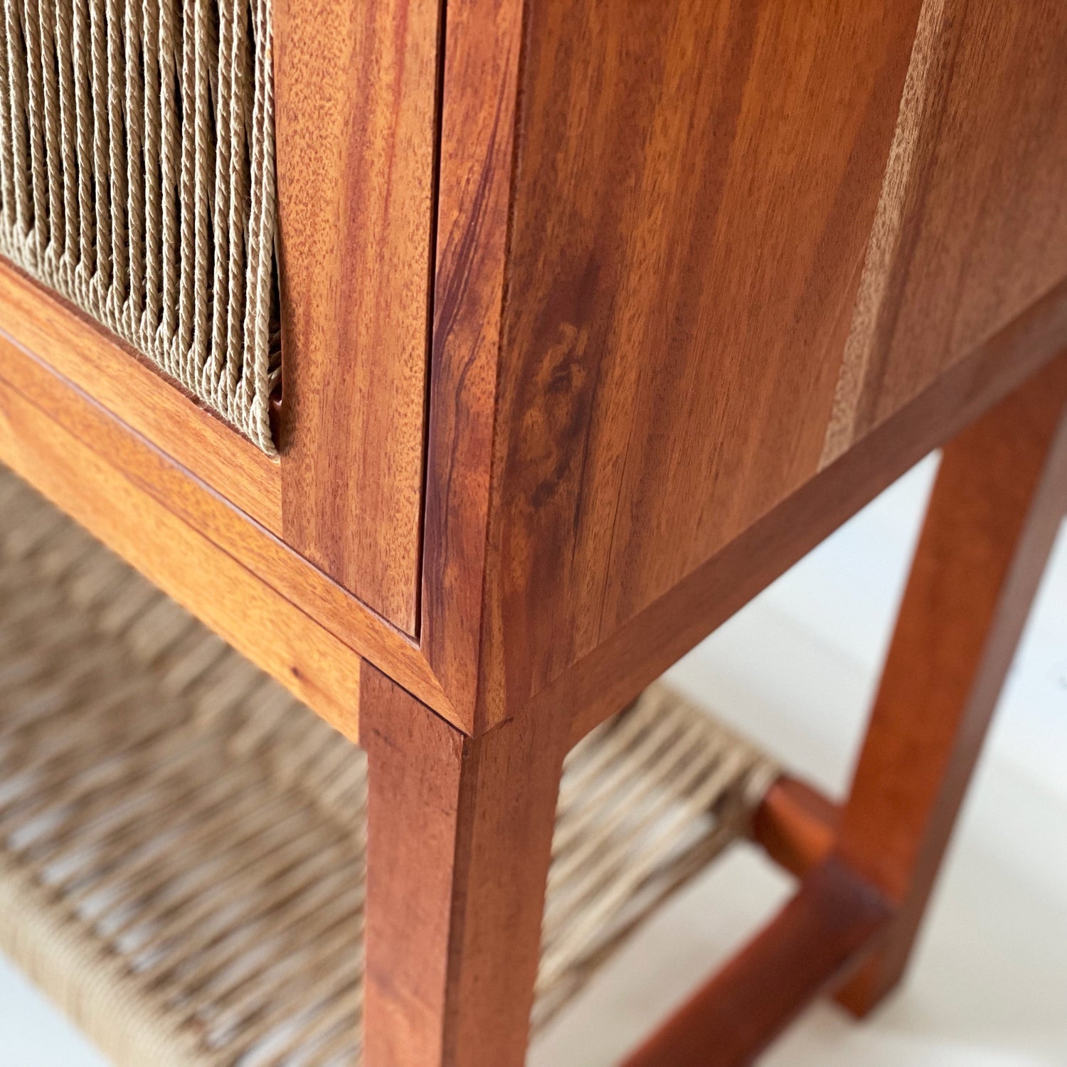 Corner view of wood and cord console.